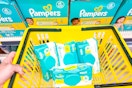 pampers wipes in a yellow shopping basket in front of pampers diapers