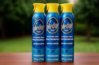 a three pack of pledge spray on table
