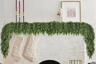 a christmas garland over a fireplace