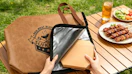 a hand putting a plate of meat in a meat resting bag