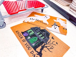 halloween doormats together in front of a parked target cart