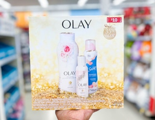 hand holding Olay/Secret holiday gift set