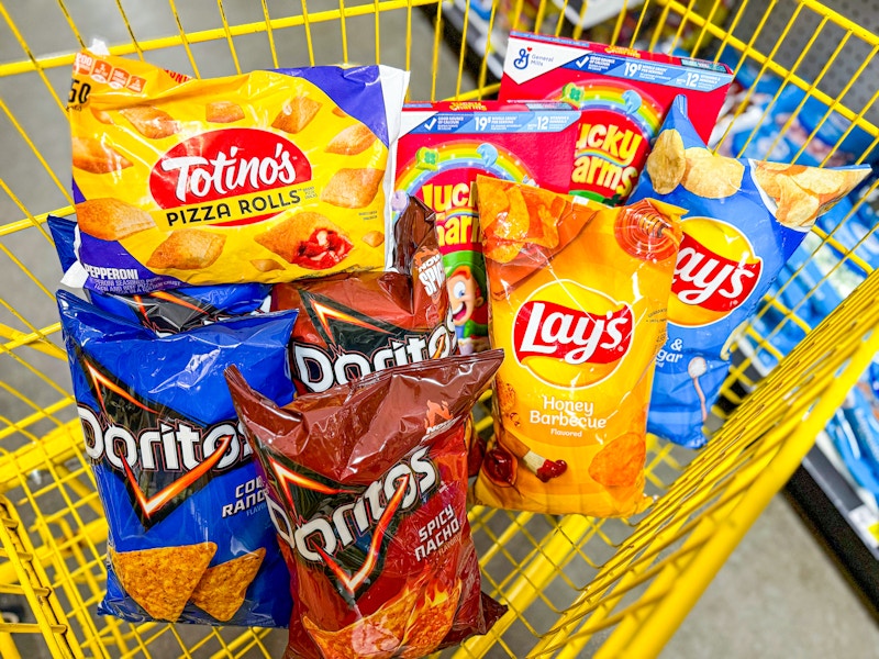 6 bags of chips, totinos pizza rolls, and 2 boxes of lucky charms in a cart