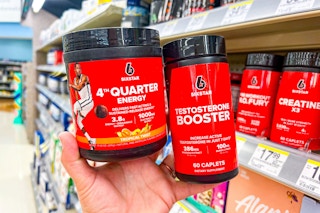 hand holding two six star workout supplements