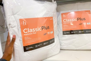 hand holding mattress pad