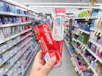 hand holding colgate oral care in walgreens