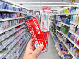 hand holding colgate oral care in walgreens