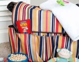 butt rash cream in a stripe diaper bag