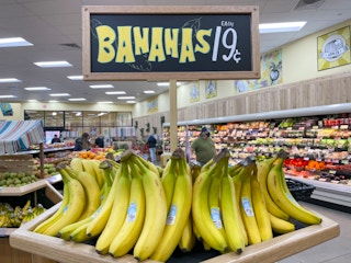 Bananas on a stand with a sign above them reading, "Bananas $0.19 each"