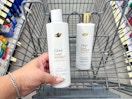 hand holding dove shampoo and conditioner in cart