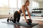 a woman using an ab roller