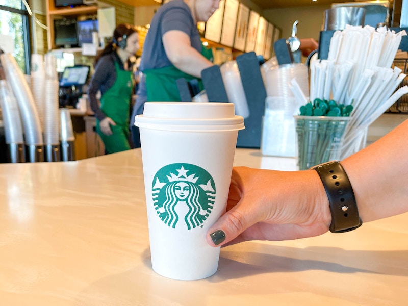 a Starbucks drink being grabbed from the counter at Starbucks