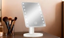 a lighted mirror on a desk