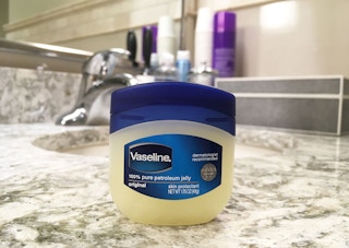 a jar of vaseline on a bathroom sink counter