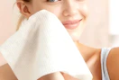 a person using a disposable face towel 