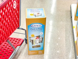 graco playard sitting next to a target cart