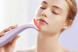 a woman using a red light device