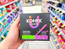 hand holding kotex tampons in walgreens