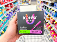 hand holding kotex tampons in walgreens