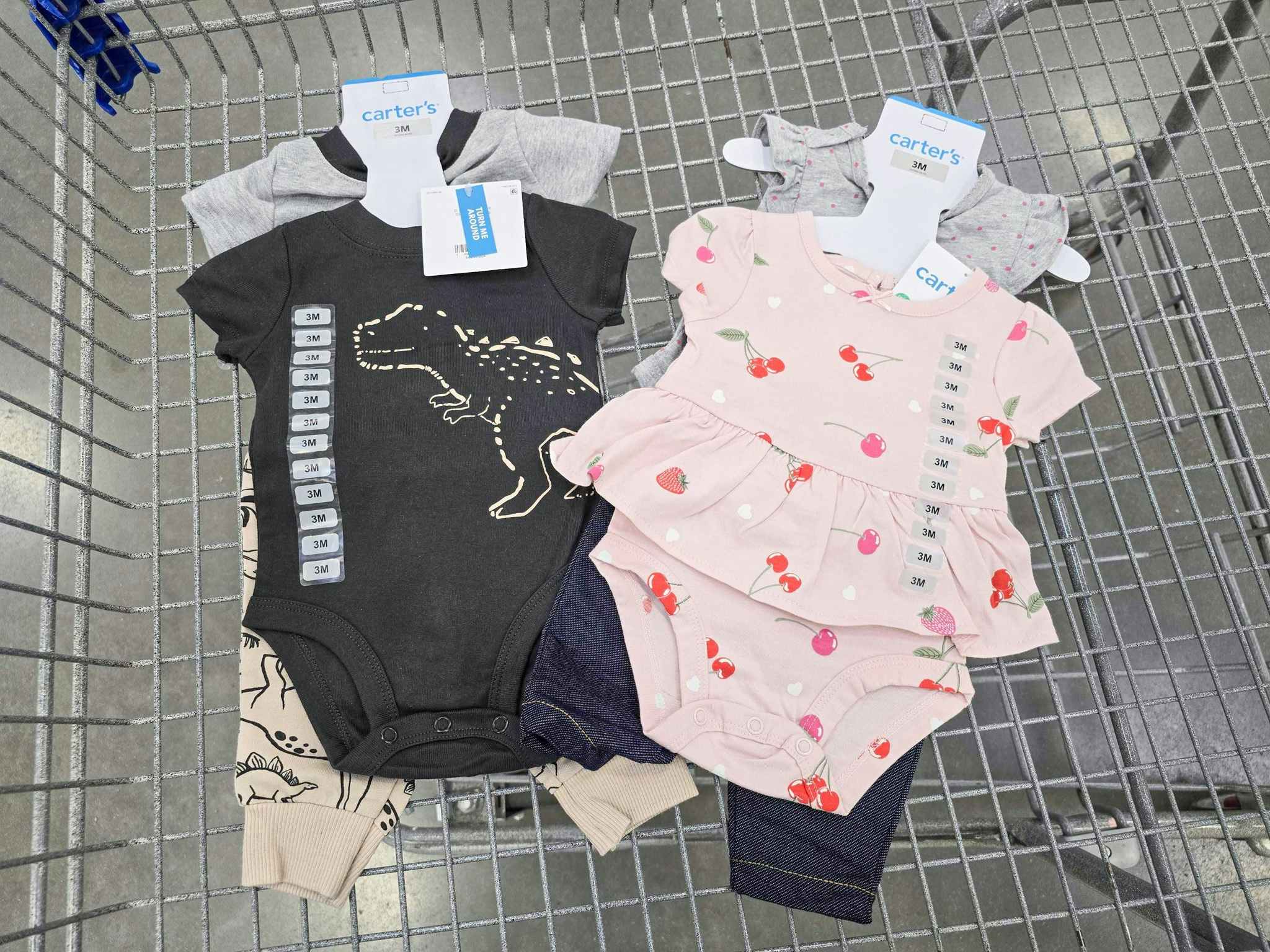 2 carters baby outfits in a cart