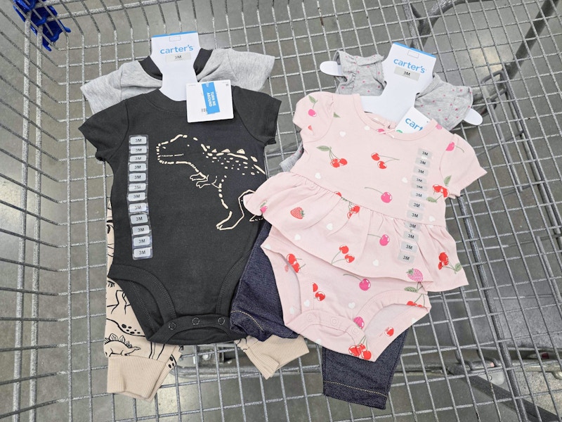 2 carters baby outfits in a cart