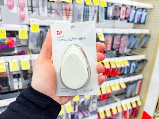 hand holding cosmetic blending sponges in walgreens