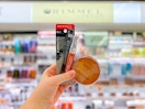 hand holding three rimmel cosmetics products