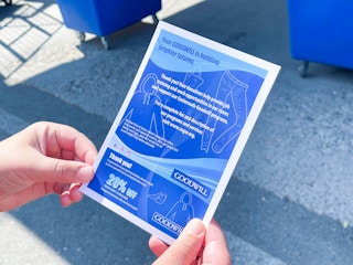 a person holding goodwill donation coupon and tax receipt