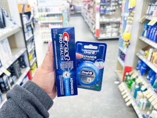hand holding crest and oral-b in walgreens