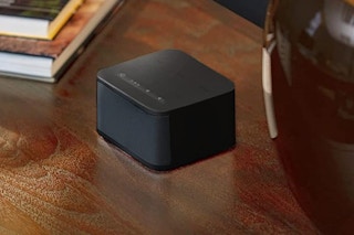 A white noise machine on a nightstand