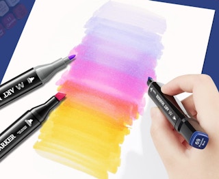 a hand coloring with colorful markers on a sheet of paper