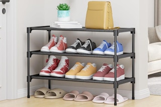 a black shoe rack near a door