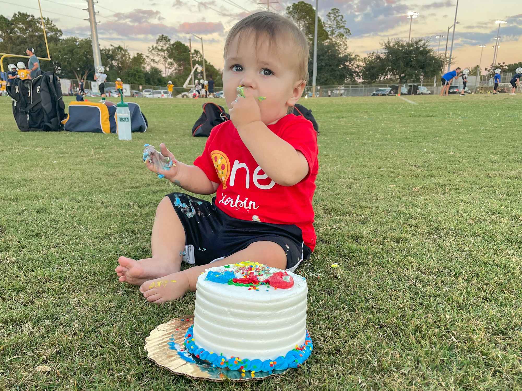 A baby eating a small smash cake