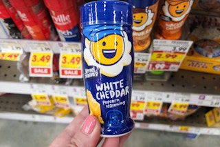 hand holding a bottle of kernel season's popcorn seasoning at kroger