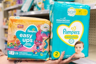 hand holding pampers diapers